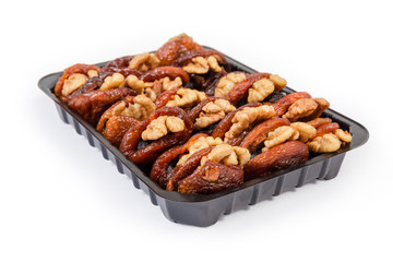 Dried apricots stuffed with walnuts in packaging close-up