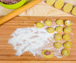 Homemade meat dumplings on the cutting board during preparation
