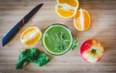 Good morning: Fresh green smoothie and fruits on wooden background, healthy breakfast