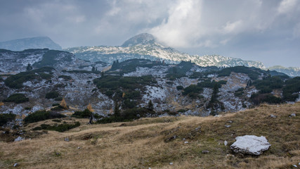 Panoramic landscape rocky mountains Styrian Alps in Austria. High peaks of mountains. Fast change of weather sun and clouds.