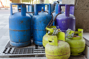 Multi-colored and different-sized gas cylinders on the street.  Bottles with liquefied petroleum gas (LPG), Propane-butane for home use. Jimbaran, Bali.