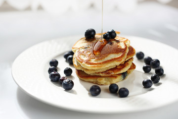  Pancakes with blueberries and maple syrup. Sweet breakfast.
