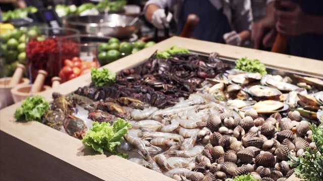 Row seafood in Bangkok food court: shripms, mussels, scallops. Thailand