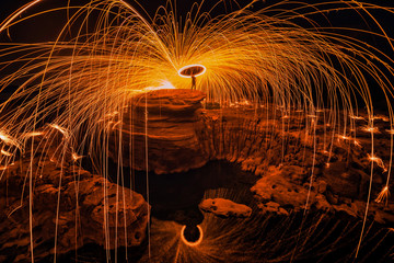 Burning steel wool on the rock near the river.