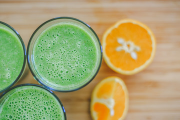 Good morning: Fresh green smoothies and fruits on wooden background, healthy breakfast