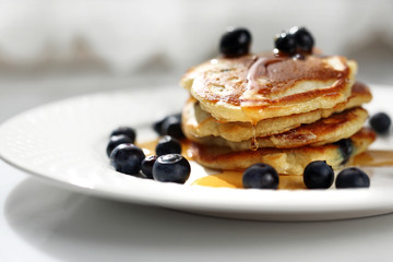  Pancakes with blueberries and maple syrup. Sweet breakfast.