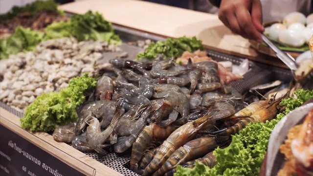 Row seafood in Bangkok food court: shripms and mussels. Thailand