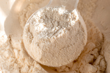 Whey protein scoop. Close-up sports nutrition.