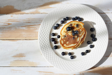  Pancakes with blueberries and maple syrup. Sweet breakfast.
