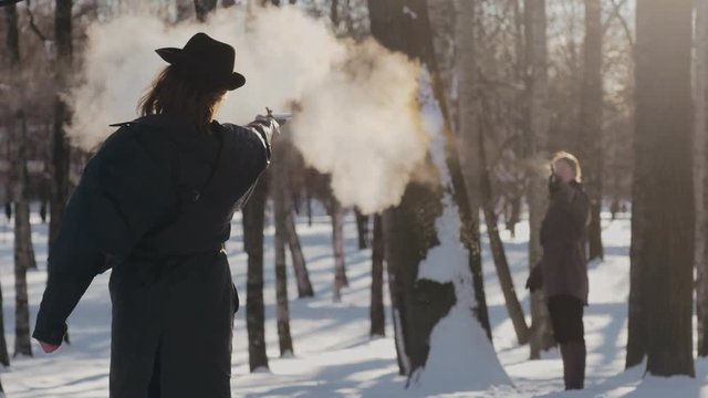 Duelist killing his rival with pistol in forest