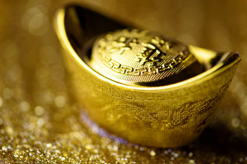 Chinese gold ingot on gold background