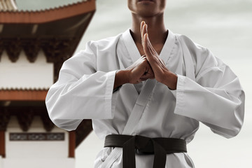 Midsection of man practicing karate