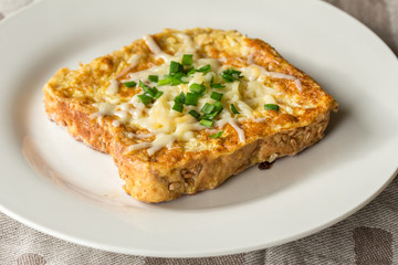 Savoury cheesy French toast with chives garnish close up - horizontal photo