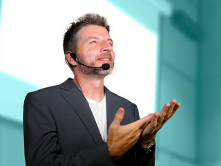 confident successful man with headset speaking at corporate business coaching and training...