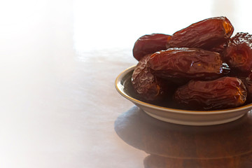 The Concept Of Ramadan.  Dates on a wooden table.  Place for text.