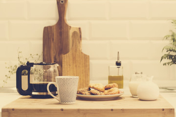Taza de café cafetera y croissantes desayuno