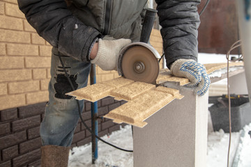 Installing brick siding on the wall of the house