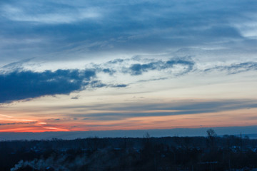 Beautiful winter dawn. Sunlight through the clouds in the morning in winter.