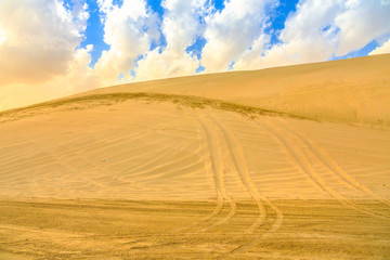Fototapeta na wymiar Desert safari adventure at Khor Al Udeid, Persian Gulf, Middle East. Desert landscape sand dunes near Qatar and Saudi Arabia. Inland sea is a major tourist destination for Qatar.