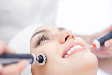 Cosmetology. Close-up of microcurrent and ultrasound procedure for face. Rejuvenation and lifting.