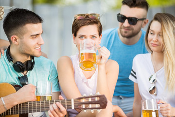 Young group of people with a beer outdoors