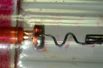 Microscopy of the interior of a 1970's type germanium diode type OA85 in glass body. Left is anode,...