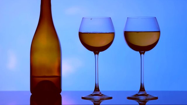 Image of glasses, bottles and alcohol on a sky background.
