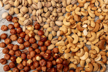 pistachio nuts cashew hazelnuts on wooden background