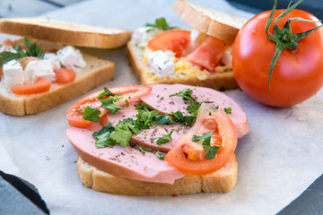 sandwich with sausage ,tomato and herbs