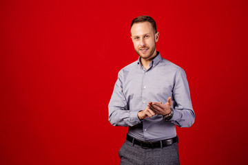 Man talking over red background. teaching, explaining,  people and emotion concept.
