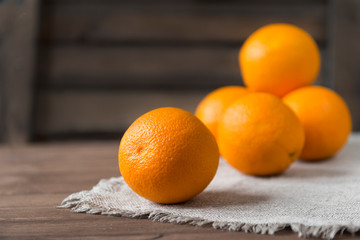 lots of oranges on a napkin on a wooden background