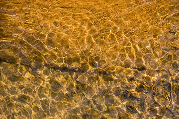 Top view pattern of water on the stone that is affected from light distortion.