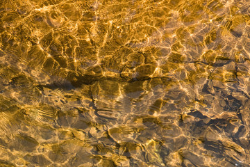 Top view pattern of water on the stone that is affected from light distortion.