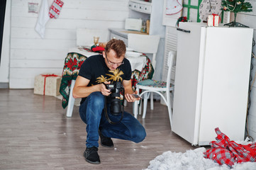 Man photographer looking at camera for result what him shoot on studio. Professional photographer...