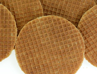Stack of Dutch stroopwafel cookies or caramel waffles isolated on white.