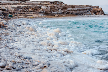 .incredibly beautiful seaside of the dead sea with blue water and white crystals of salt...