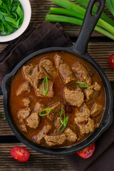 Beef stew in tomato sauce and cherry tomatoes