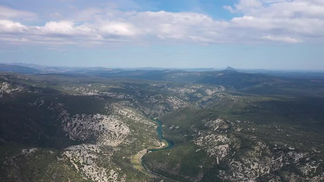 Herault river global aerial view with the mountain Pic Saint Loup in background. France Occitanie