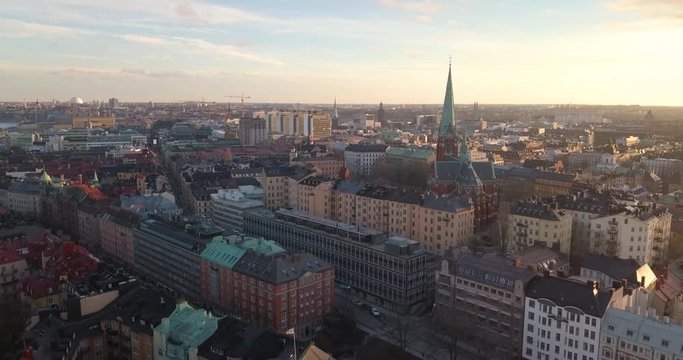 Beautiful tilt up aerial drone view spring sunset Stockholm Sweden. Drone overlooks Ostermalm, stunning Swedish urban golden hour. Colorful scenic sunny cityscape.