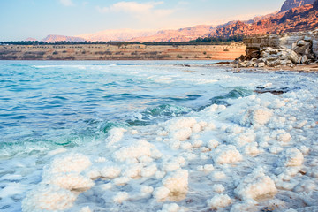 .incredibly beautiful seaside of the dead sea with blue water and white crystals of salt...