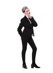 Young alternative looking, stylish businesswoman wearing a black suit with shirt and tie, full length on a white background