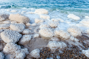 .incredibly beautiful seaside of the dead sea with blue water and white crystals of salt...
