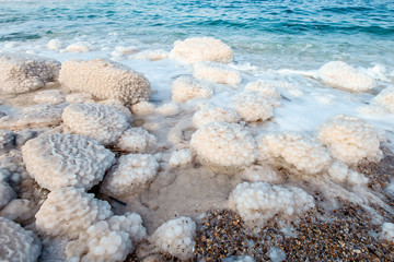 .incredibly beautiful seaside of the dead sea with blue water and white crystals of salt...