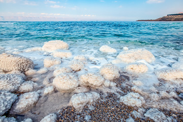 .incredibly beautiful seaside of the dead sea with blue water and white crystals of salt...