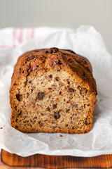 Banana cake on a wooden background with a glass of milk