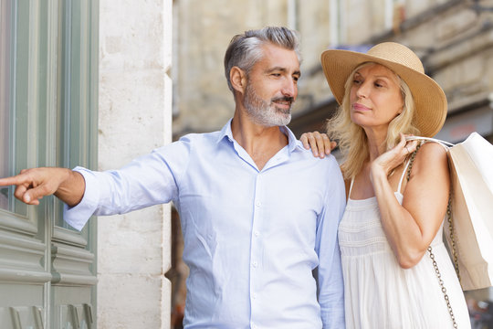 Joyful Couple Looking Away On Walkway In City