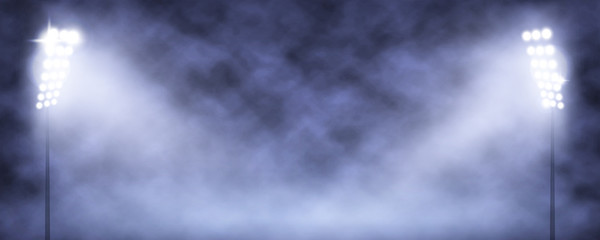 Spotlight Towers on Night Stadium in Smoke.