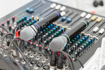 Microphone close-up. Focus on mic. Event concept. Music mixer equalizer console for mixer control...