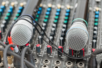 Microphone close-up. Focus on mic. Event concept. Music mixer equalizer console for mixer control...
