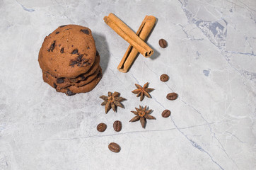 chocolate cookies with cinnamon and coffee on the table